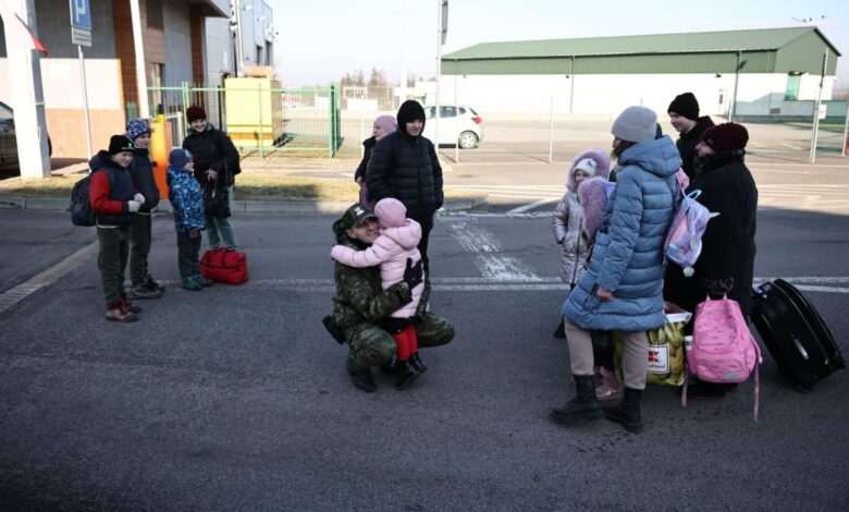 Funkcjonariusz polskiej straży granicznej przytula dziecko na jednym z przejść granicznych z Ukrainą. [fot. MSWiA]