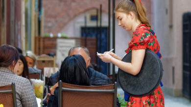 Wakacyjna praca studenta - kelnerka przyjmuje zamówienie