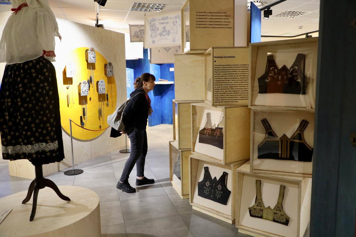 Muzeum „Górnośląski Park Etnograficzny w Chorzowie”  zaprasza na wystawę - kobieta oglądająca wystawę