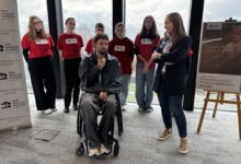 DOm aniołów Stróżów, Grupa ludzi wokół mężczyzny na wóżku